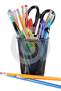 Full pencil cup with scissors, pencils and pens