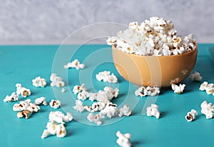 Full plate of popcorn, movie concept, close up of popcorn in bowl of salted popcorn at the old wooden table. Dark background.