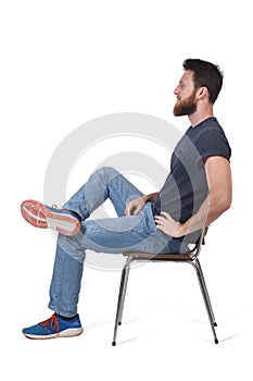 Full portrait of a man sitting on a chair on white