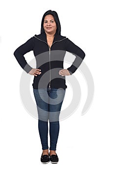 Full portrait of woman standing on white background,hands on hip