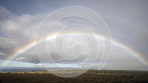 Full rainbow over a field of hardened lava on the Big Island, Hawaii.