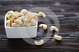 Full Raw Cashew Nuts in white ceramic bowl