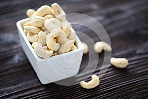 Full Raw Cashew Nuts in white ceramic bowl