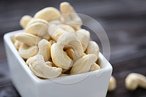 Full Raw Cashew Nuts in white ceramic bowl