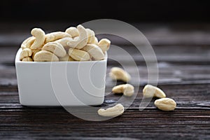 Full Raw Cashew Nuts in white ceramic bowl