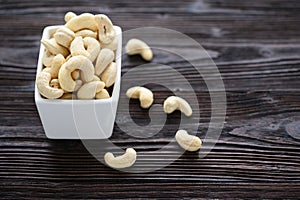 Full Raw Cashew Nuts in white ceramic bowl