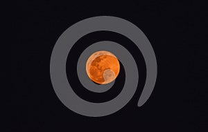 The full red moon in black sky