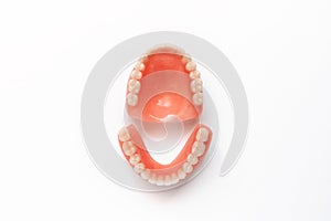 Full removable plastic denture of the jaws. Set of dentures on a white background. Two acrylic dentures. Upper and lower jaws