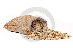 A full sack of oats lies on a white background. Close-up.