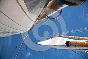 Full Sails on Wooden Masts of Saliboat with Blue Sky