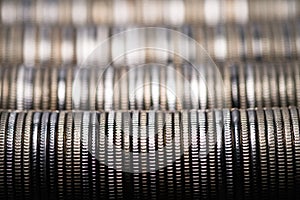 Full-screen background of horizontal stacks of silver metal coins