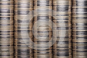 Full-screen background of silver metal coin stacks