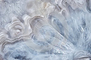 Full-screen close-up texture of light blue-white agate