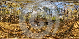 Full seamless hdri 360 panorama near mountain stream in tree-covered ravine in autumn forest in sunny day equirectangular