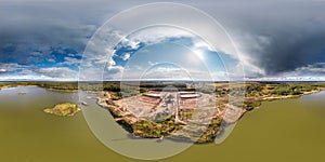 full seamless spherical hdri 360 panorama aerial view over chalkpit on limestone coast of quarry with green water in evening in