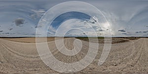 Full seamless spherical hdri 360 panorama view on no traffic gravel road among fields in summer evening sunset with awesome clouds