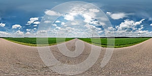 Full seamless spherical hdri panorama 360 degrees angle view on asphalt road among fields in summer day with awesome clouds in