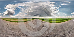 Full seamless spherical hdri panorama 360 degrees angle view on asphalt road among fields in summer day with awesome clouds in