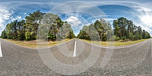 Full seamless spherical hdri panorama 360 degrees angle view on asphalt road among pinery forest in summer day with awesome clouds