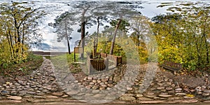 Full seamless spherical hdri panorama 360 degrees angle view bench for rest at grave with monument in the forest  in