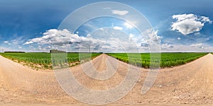 Full seamless spherical hdri panorama 360 degrees angle view on gravel road among fields in summer day with awesome clouds before