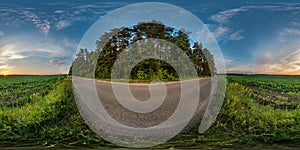 Full seamless spherical hdri panorama 360 degrees angle view on gravel road among fields in summer evening sunset with awesome