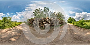 Full seamless spherical hdri panorama 360 degrees angle view on gravel road near firewood in summer day with awesome clouds in