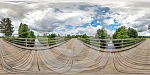 Full seamless spherical hdri panorama 360 degrees  angle view on wooden bridge over the river canal in equirectangular projection