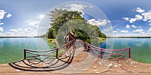 Full seamless spherical hdri panorama 360 degrees  angle view on wooden pier of huge lake or river in sunny summer day and windy