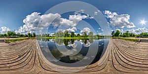 Full seamless spherical hdri panorama 360 degrees angle view on wooden pier of lake or river in morning or sunset with beautiful
