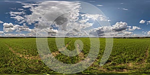 Full seamless spherical hdri panorama 360 among green farming fields in summer day with awesome clouds in equirectangular