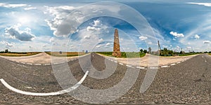 Full seamless spherical hdri panorama 360 degrees angle view on asphault road near ancient stella in summer day with awesome