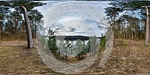 Full seamless spherical panorama 360 degrees angle view on high bank of wide river neman in evening with beautiful clouds in