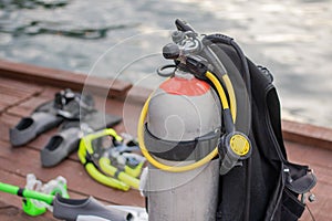 Full set of Scuba Diving equipment with selective focus on wooden pier