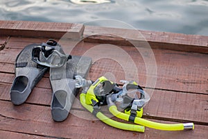Full set of Scuba Diving equipment with selective focus on wooden pier