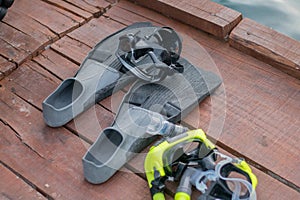 Full set of Scuba Diving equipment with selective focus on wooden pier