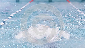 Full shot front view professional male swimmer performing butterfly stroke having training