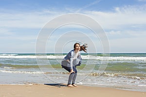 Full shot of a smily teenager just at the end of a jump in the s