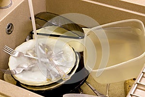 Full sink of dirty dishes, close-up photo, wash dishes after a meal.