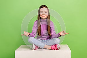 Full size body photo of beautiful small kid child girl closed eyes sitting podium balancing retreat yoga  on