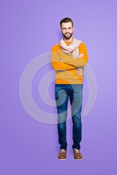 Full size fullbody portrait of joyful cheerful stylist in sweater, jeans having scarf around neck and crossed arms