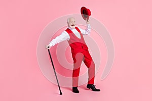 Full size photo of aged handsome man happy positive smile hold hat stick have fun isolated over pink color background