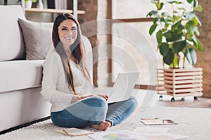 Full size photo of attractive happy positive good mood cheerful woman sit floor with crossed legs working in laptop at