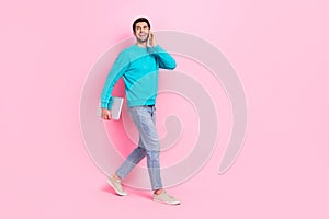 Full size photo of attractive young man hold netbook talk phone device dressed stylish blue outfit isolated on pink