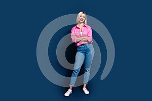 Full size photo of attractive young woman folded hands confident pose wear trendy pink clothes isolated on dark blue