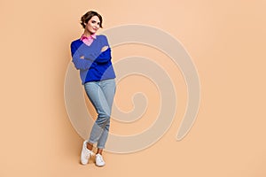 Full size photo of attractive young woman folded hands confident posing wear trendy blue clothes isolated on beige color