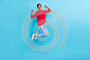Full size photo of beautiful appearance boy girl jumping point fingers herself isolated on blue color background