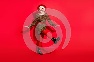 Full size photo of cheerful aged woman happy positive smile have fun dance party isolated over red color background