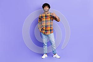 Full size photo of cheerful optimists man wear checkered shirt jeans shoes showing like approve isolated on purple color