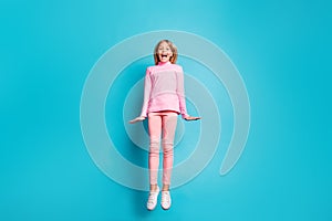 Full size photo of cool amazed nice teen girl jump air wear pink pants poloneck white footwear isolated on teal